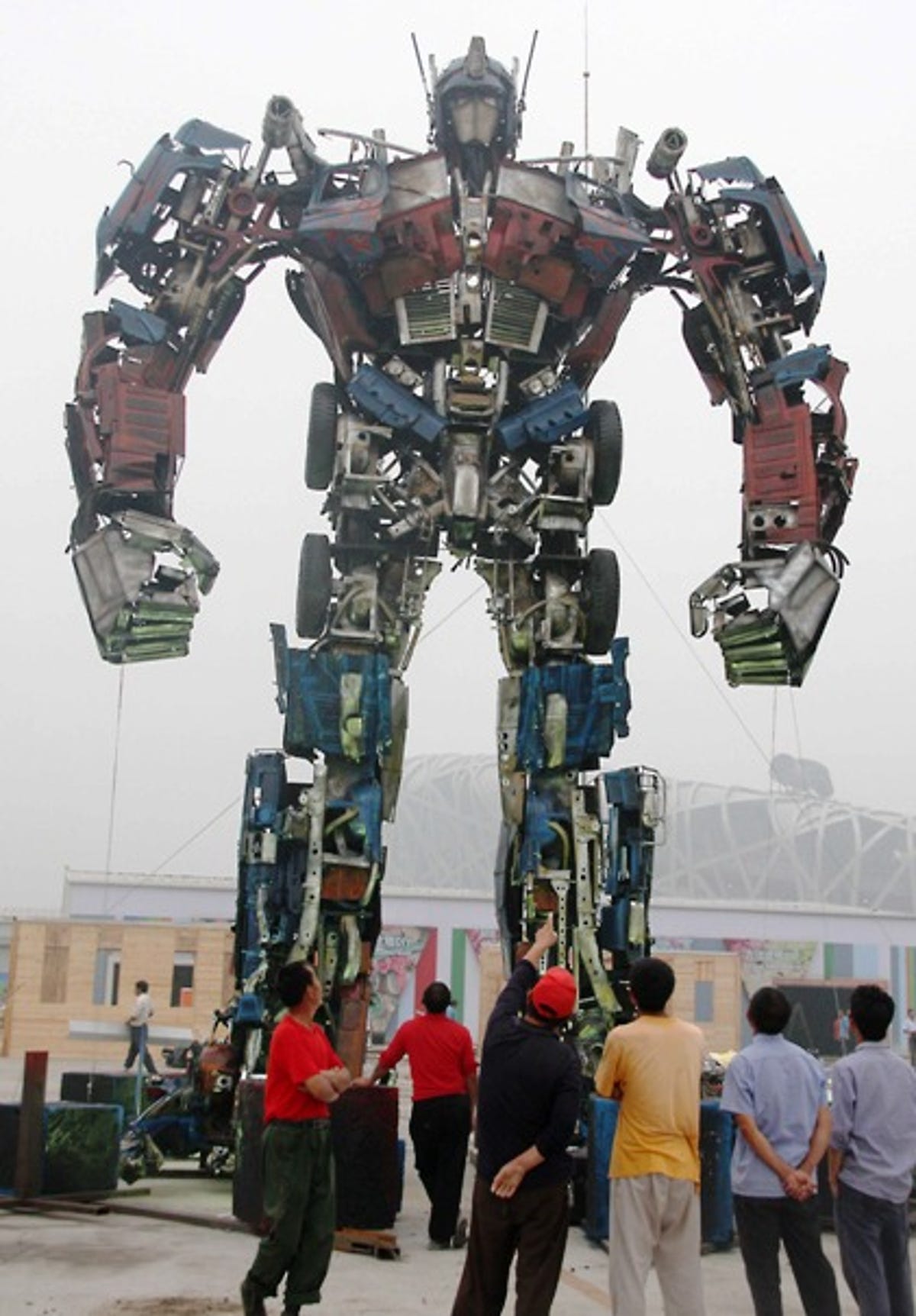 A lot o' bot: Optimus Prime towers over staff at Green Dream Park in Beijing.