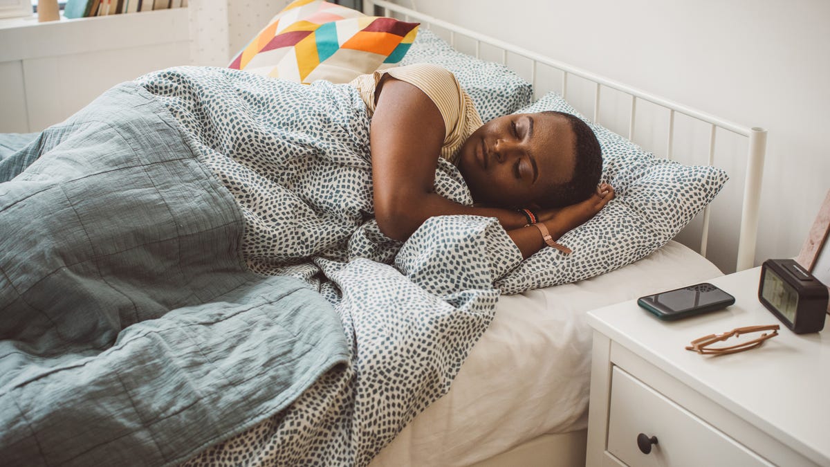 A girl sleeping on her dorm room mattress feeling comfortable