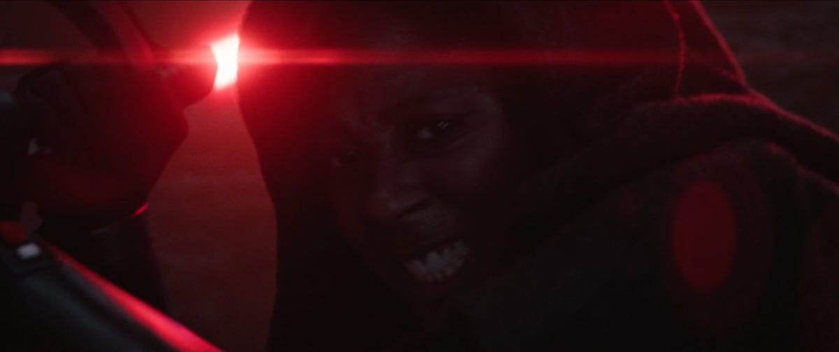 A hooded Reva grits her teeth as she raises her lightsaber in Obi-Wan Kenobi