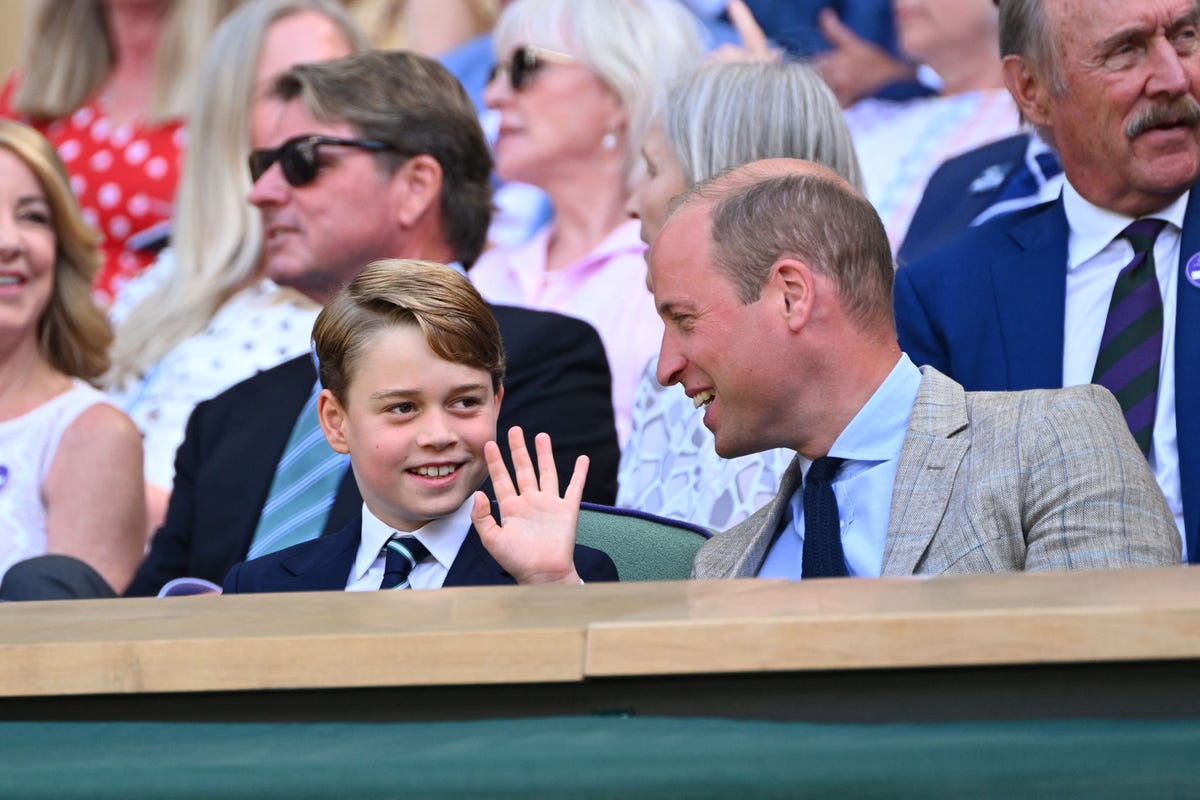 Prince George waves while sitting next to his father, Prince William