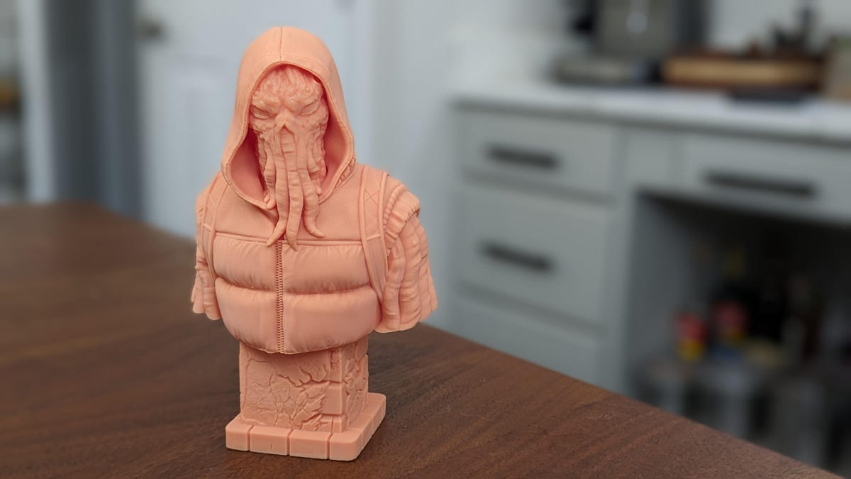A statue of Cthulhu in a hoodie with a backpack