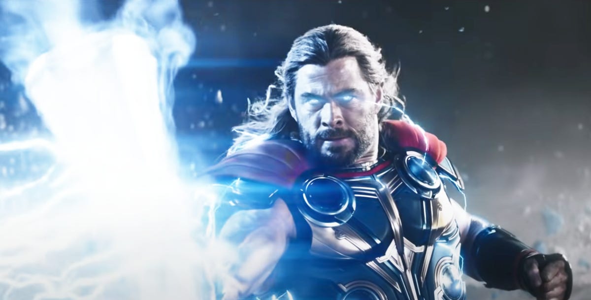 Thor holds Mjolnir with lightning illuminating his eyes
