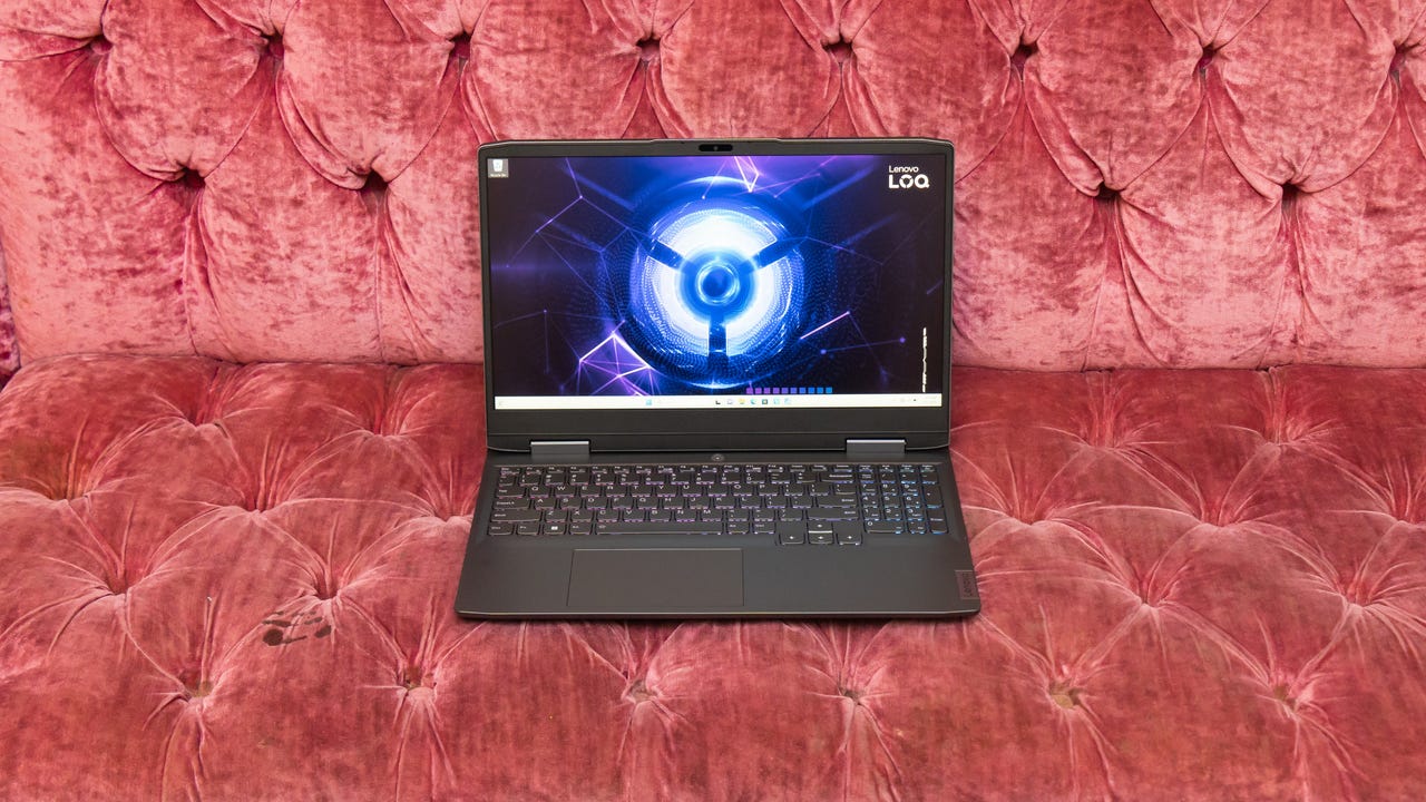 lenovo-loq-15-3480Lenovo Loq 15-inch gaming laptop open and facing forward sitting on a rose-colored tufted sofa.