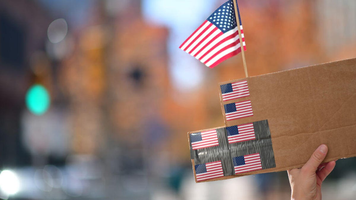 american-flag-on-cardboard-sign-getty