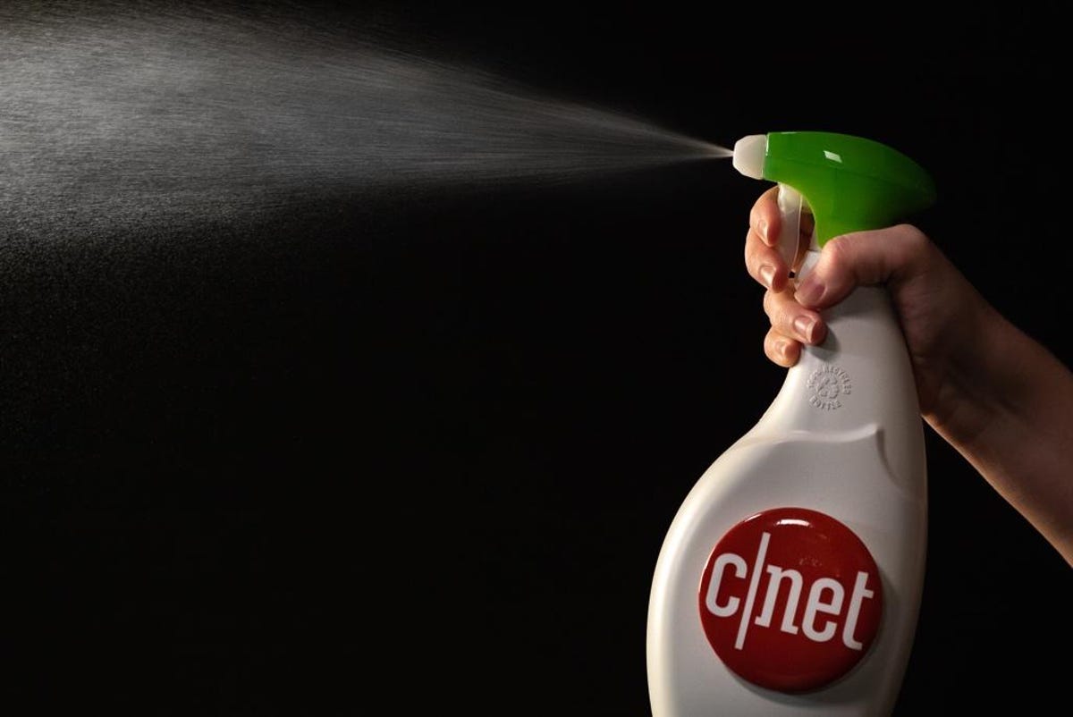 Person squeezing the handle on a bottle of cleaner