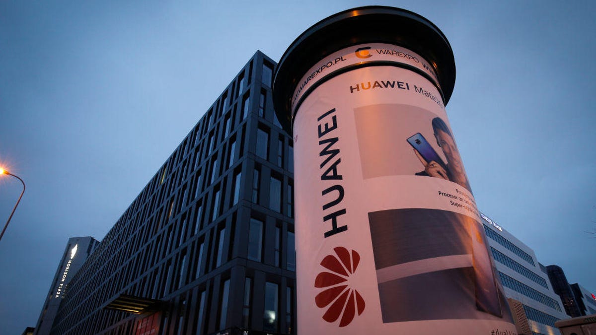 Huawei poster on a column outside an office building