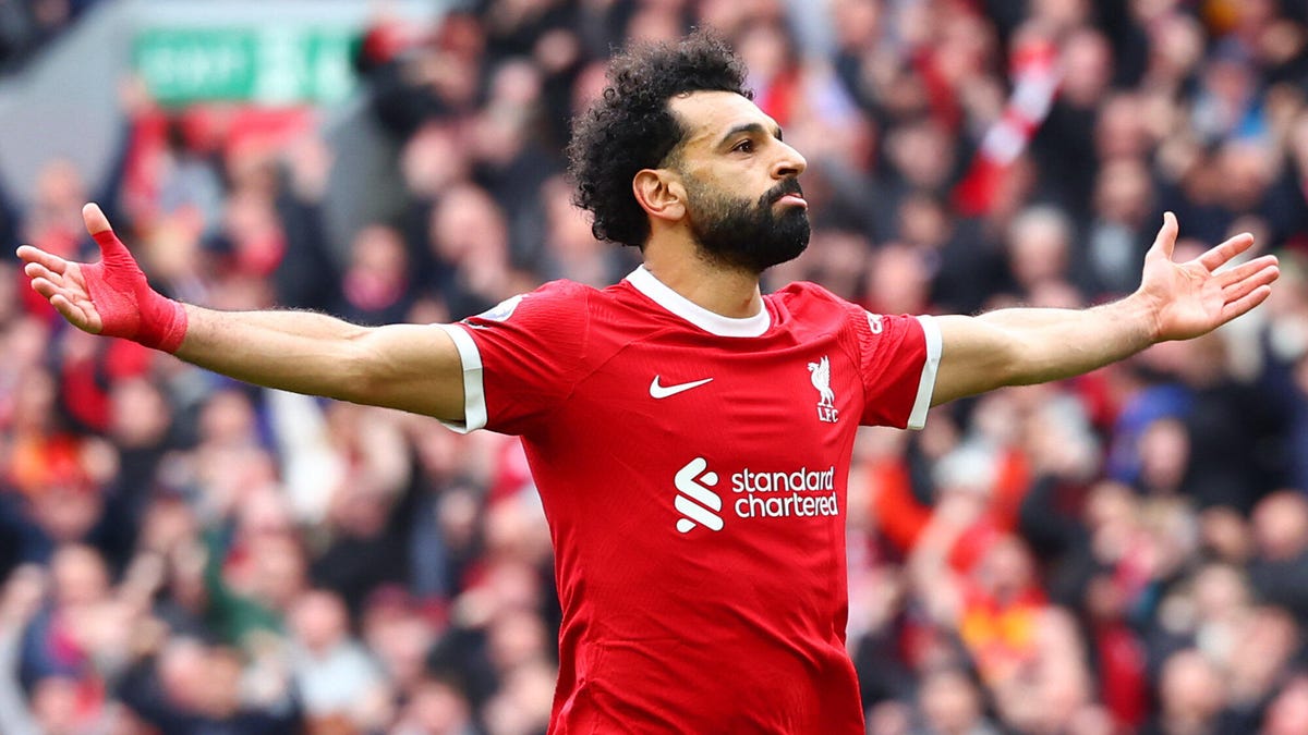 Mohamed Salah of Liverpool celebrating with both arms outstretched.