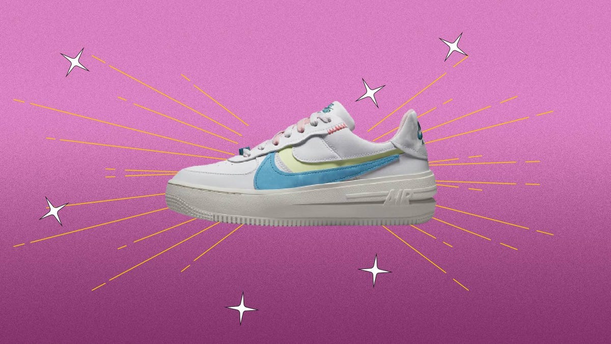 A white Nike Air Force 1 shoe against a purple background.