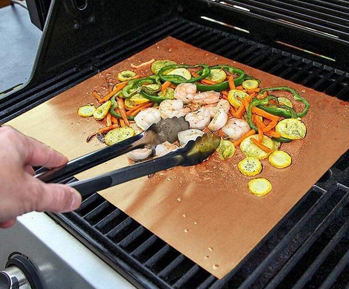 Grilled vegetables over a mat on the grill