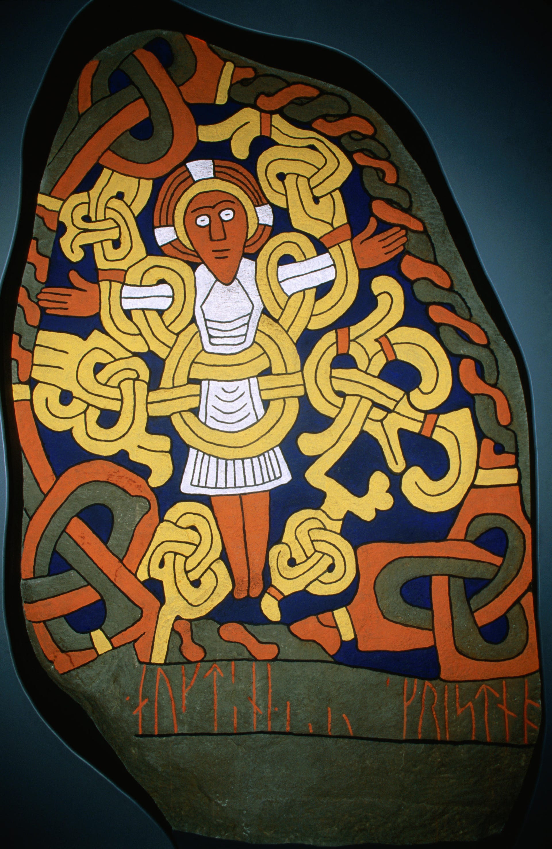 Painted re-construction of old rune stone depicting Viking Harald Bluetooth.