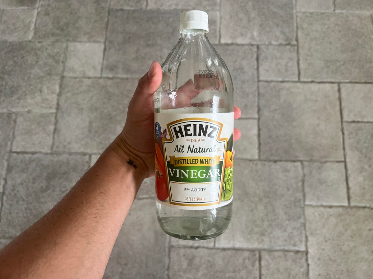 bottle of vinegar in hand