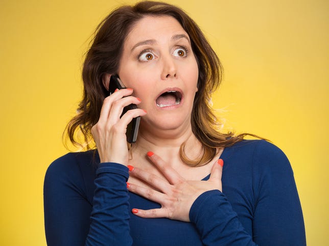 shocked-woman-phone-yellow-background.jpg
