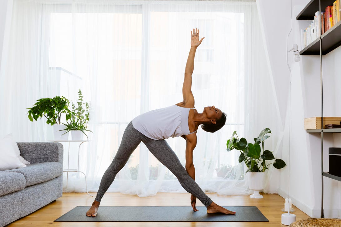 a woman does yoga in her living room