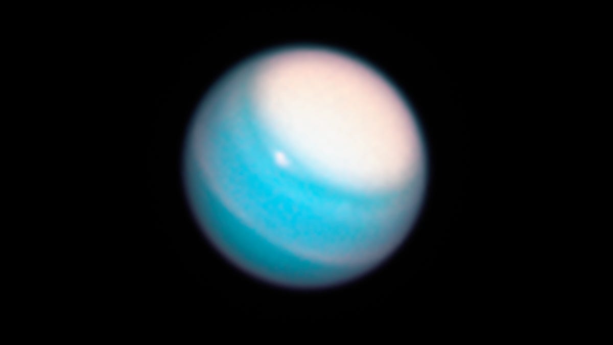 Uranus looks like a swirly blue and white marble.
