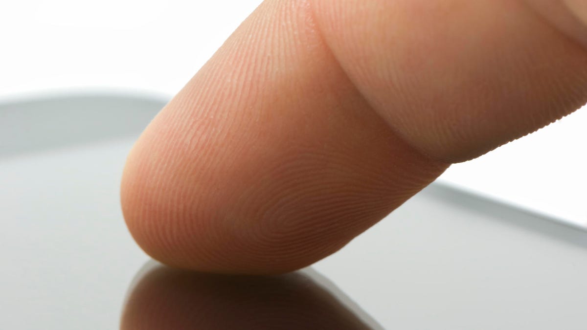Touchscreen device, finger on surface, close-up, copy space