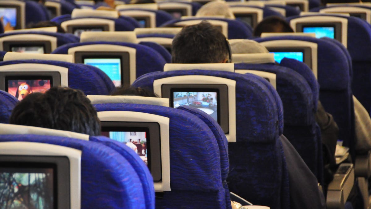 Rear View Of People Sitting In Airplane