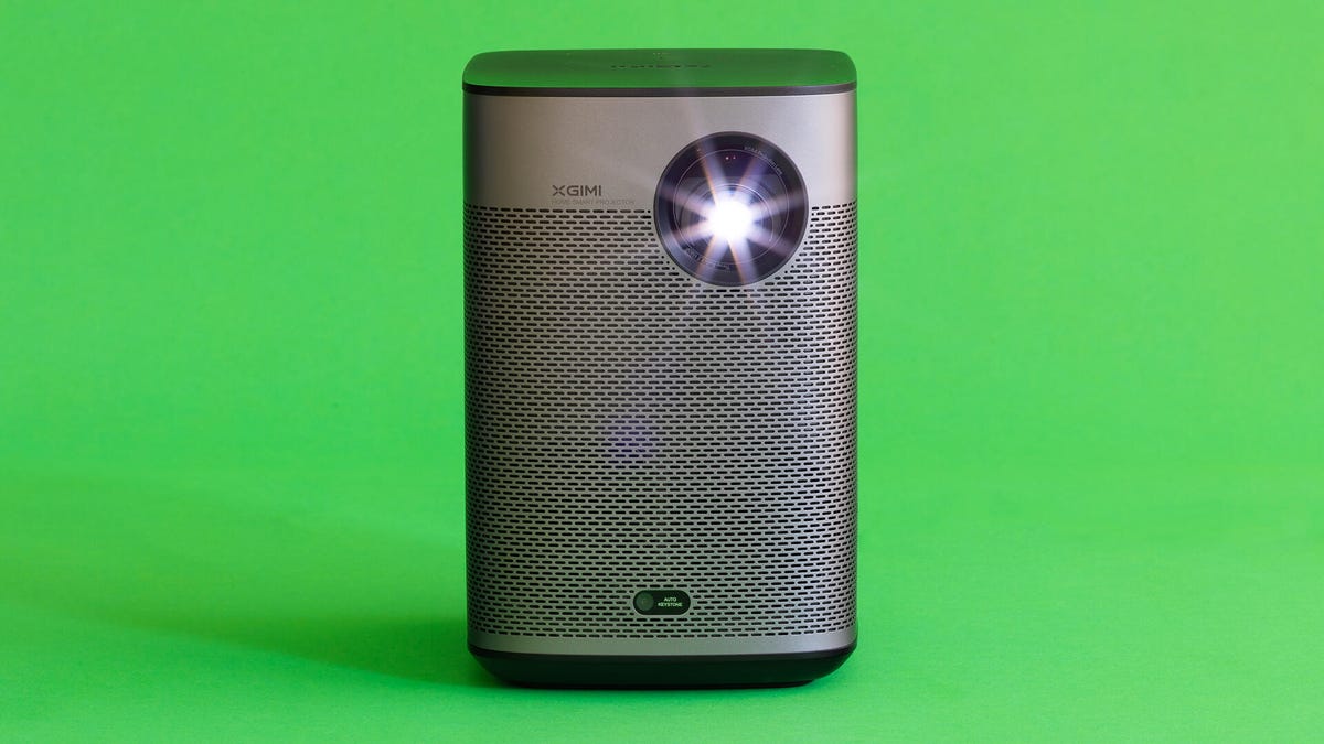A front view of the Halo+ projector by Xgimi on a green background.