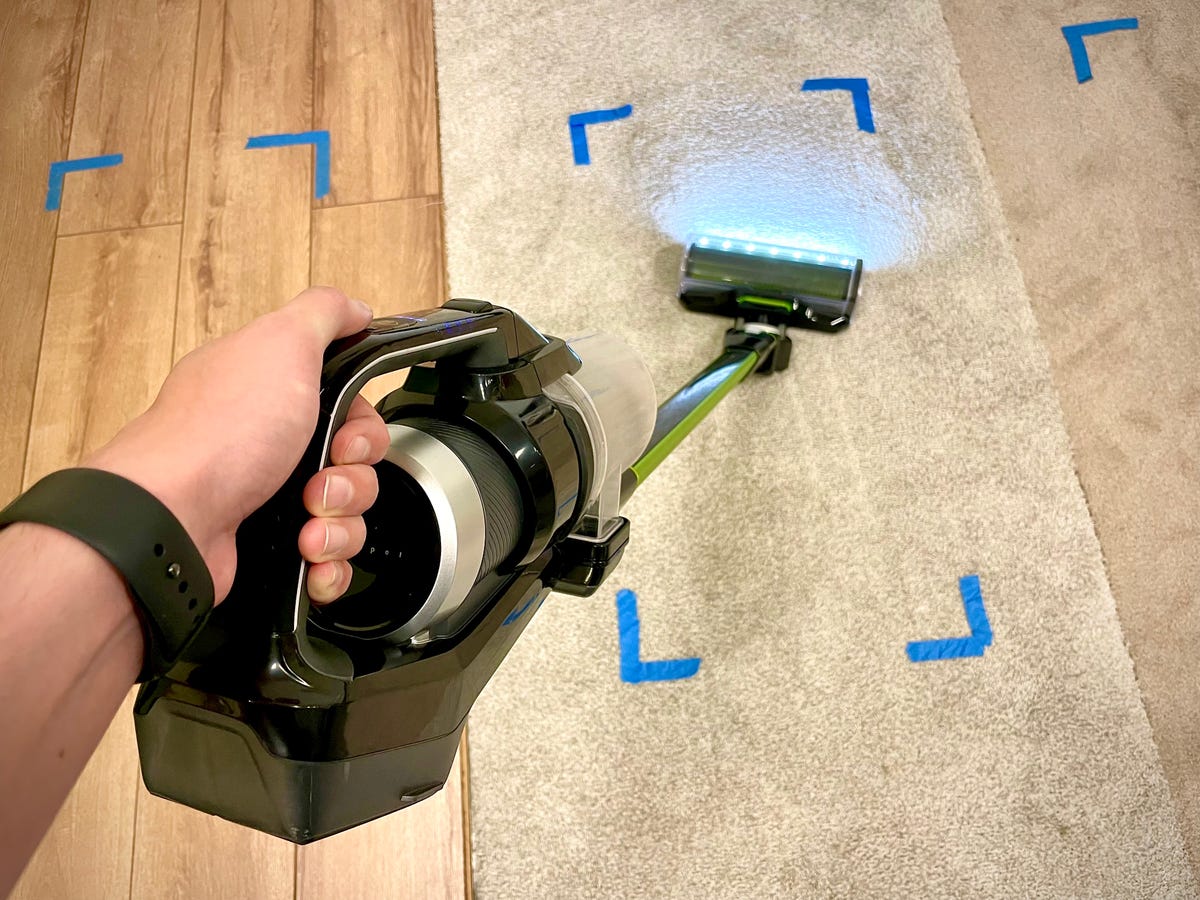 The black and green Bissell IconPet cordless vacuum in the process of cleaning the test carpets at CNET's product-testing lab in Louisville, Kentucky.