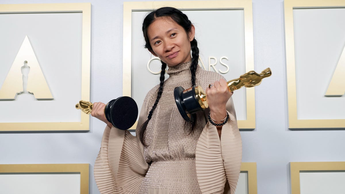 Chloé Zhao shows off double Oscars.