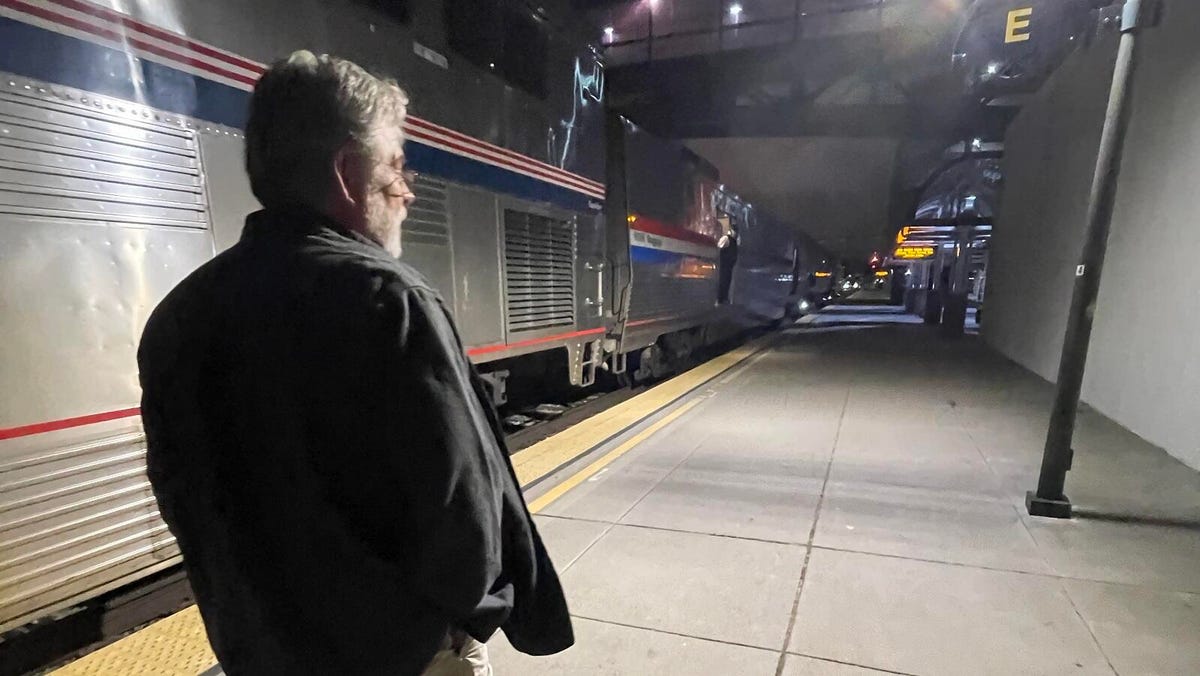 The reporter's dad walks along a train platform during a brief late night stop.