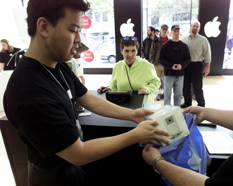 Shoppers buying the first crop of iPods in 2001.