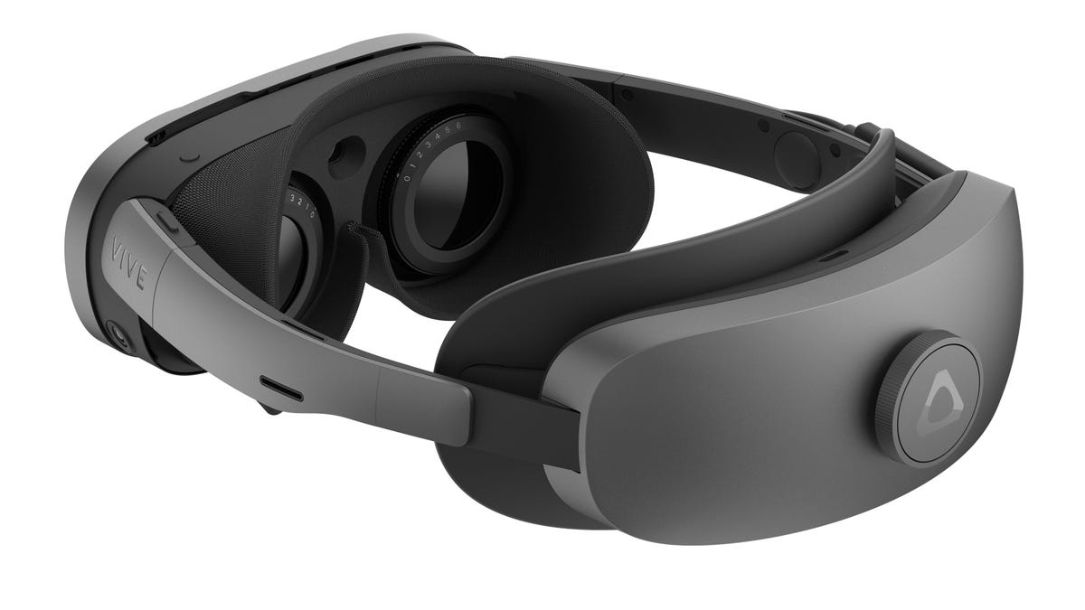 A VR headset seen from the side, looking at the lenses. Dials with numbers surround each lens.