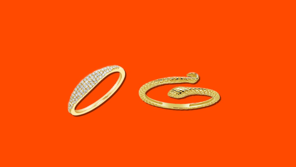 Two gold rings on an orange background
