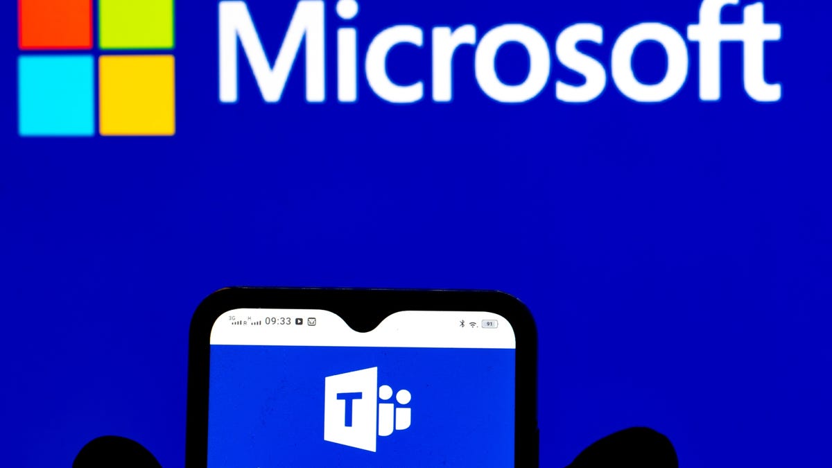 Microsoft Teams logo displayed on phone and Microsoft logo in the background