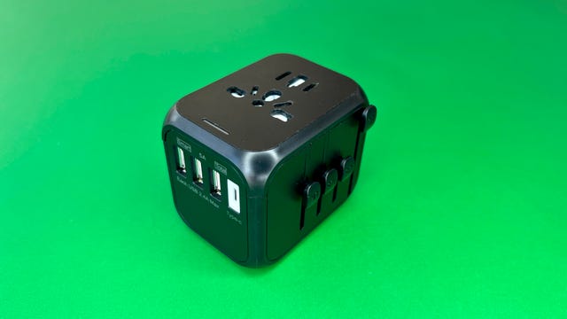 Ougrand worldwide travel power adapter on green background
