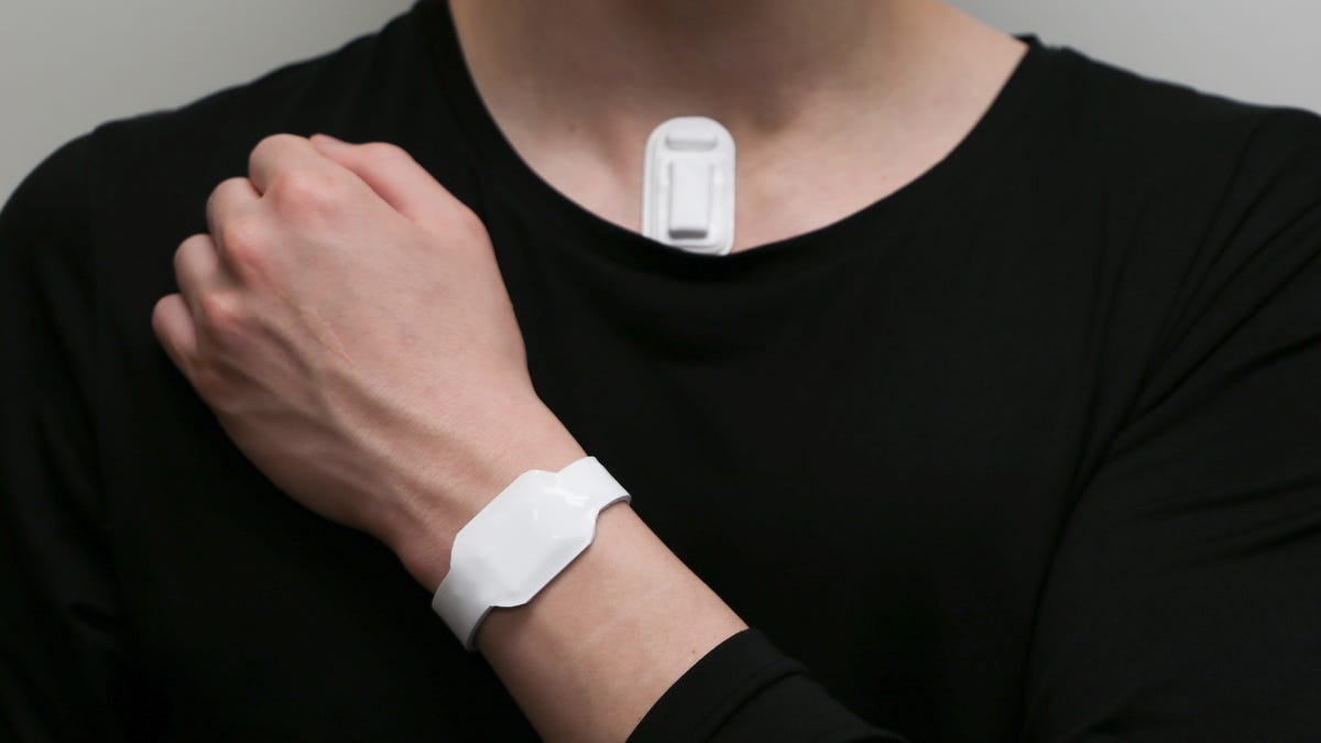 A person in a black shirt shows where the wristband and device itself would be attached.