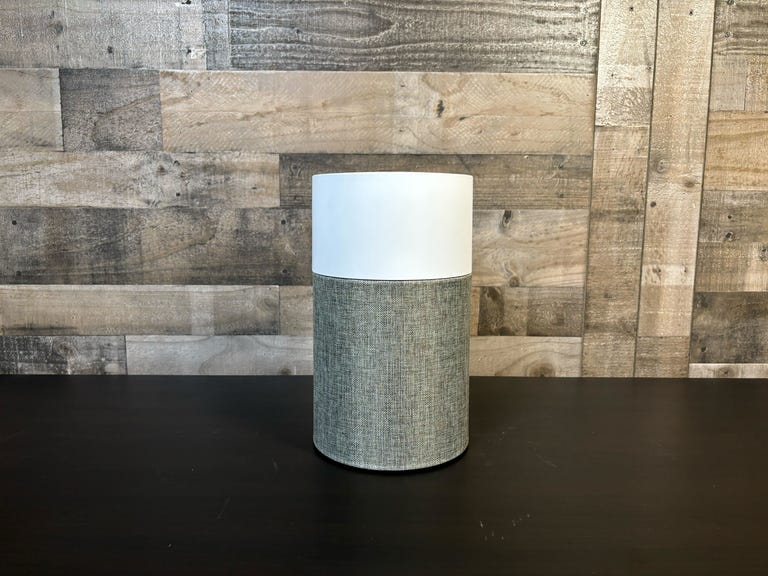 The BlueAir Pure 511 air purifier sits on a table in front of a wooden wall. It's CNET's top-rated air purifier for small spaces like bedrooms or dorm rooms, and a very sold budget pick at just $100.