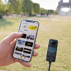 The Insta360 X3 along with its app in front of the Eiffel Tower.