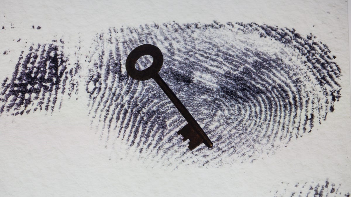Black and white fingerprint with silhouette of a key on top