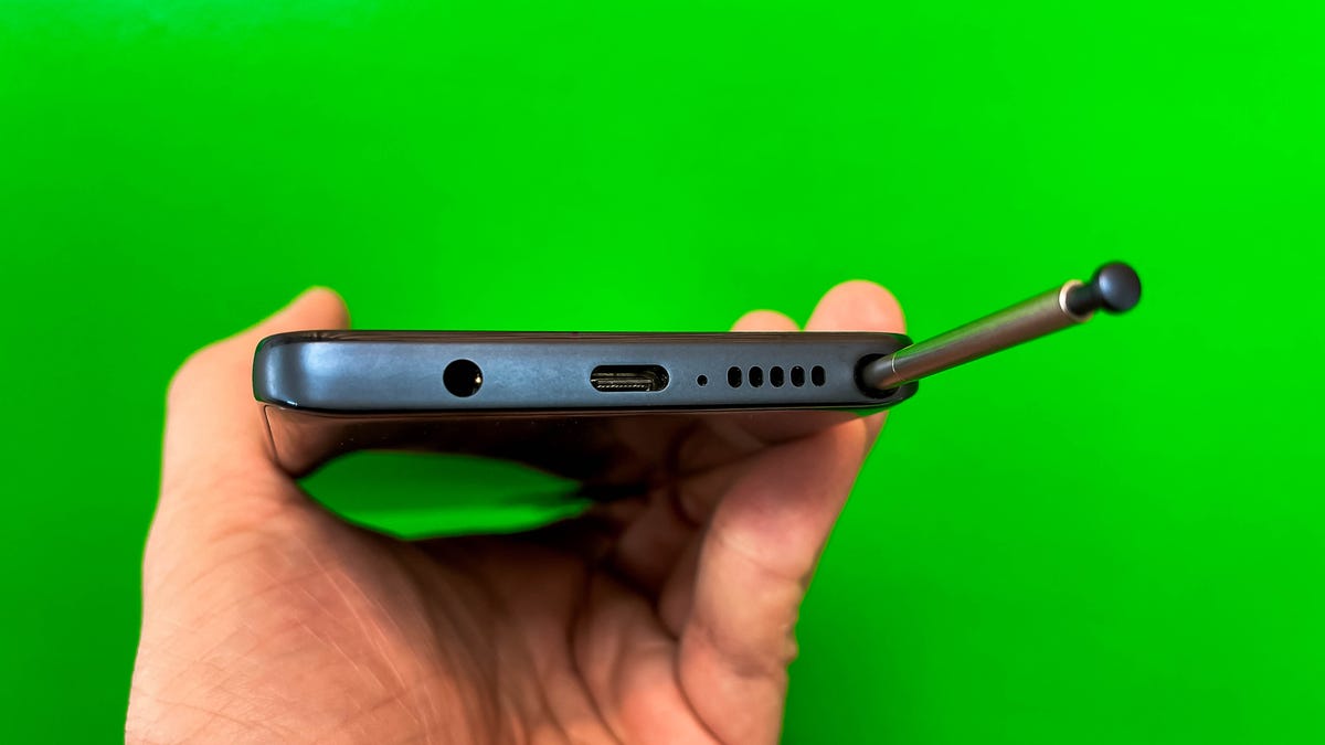 The stylus being inserted into the phone