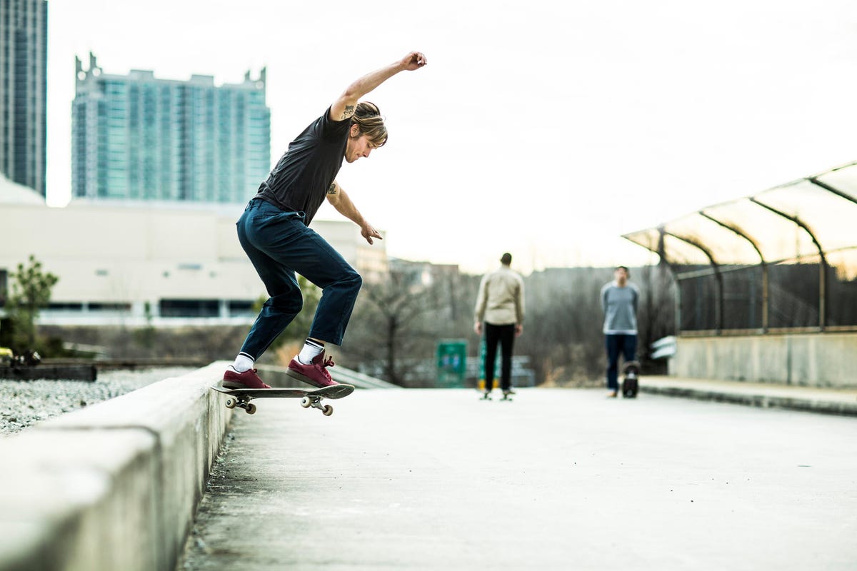 Young men skateboarding in urban environment.