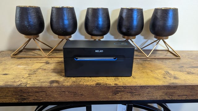 Small black printer in front of a set of candles