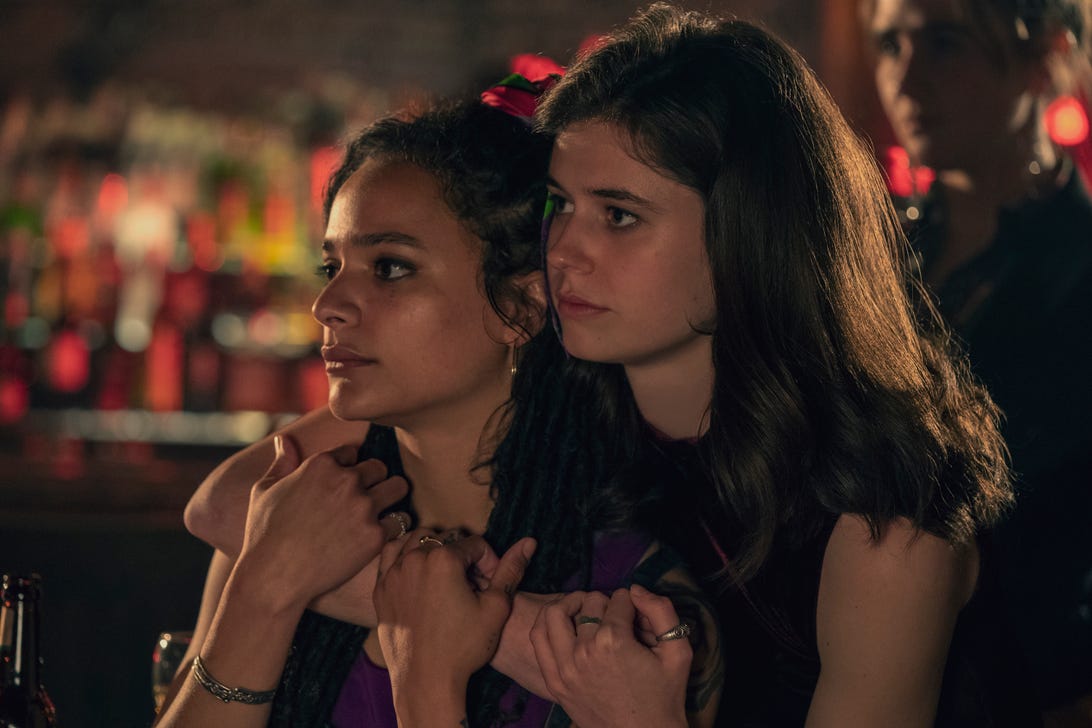 Alison Oliver stands with her arms around Sasha Lane