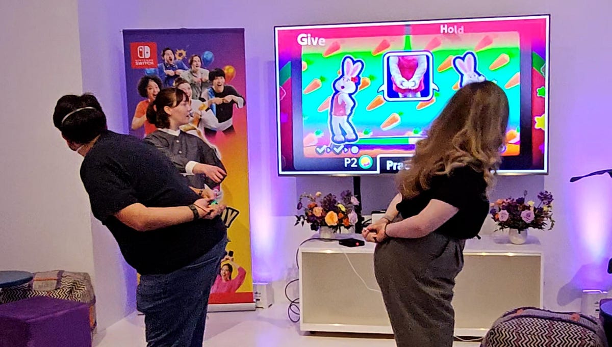 playing Everybody 1-2 Switch, two people hold their controllers behind their backs