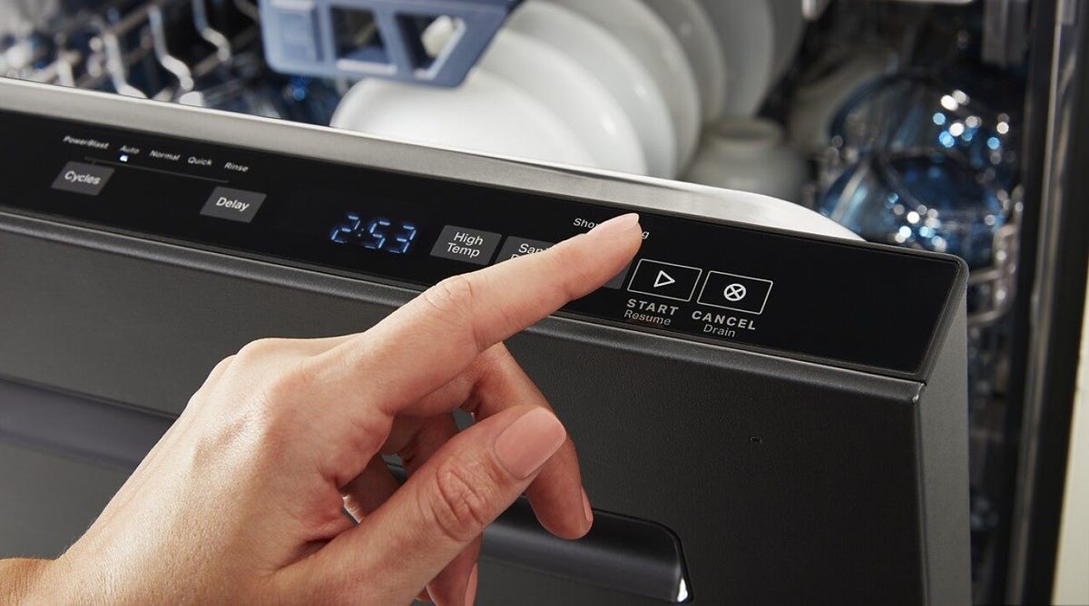 A person pressing buttons on a dishwasher