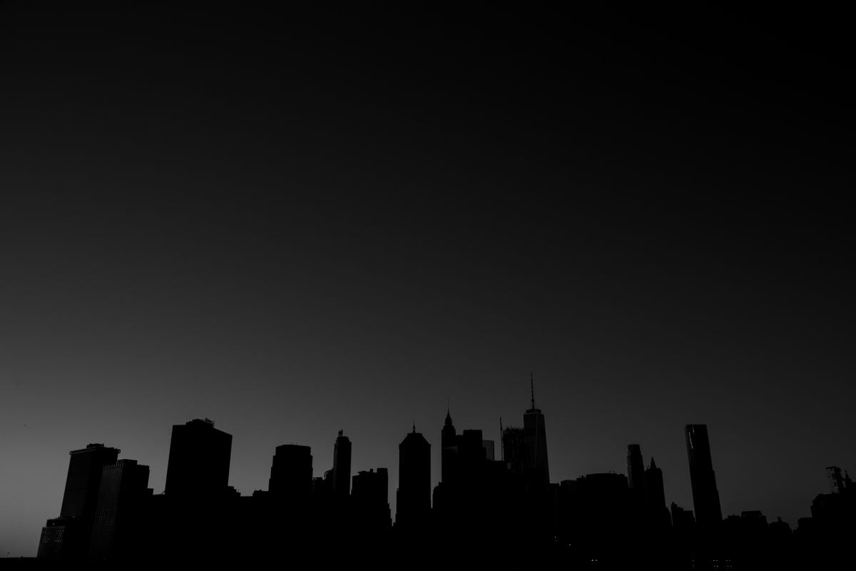 A skyline silhouetted in front of a dark sky.