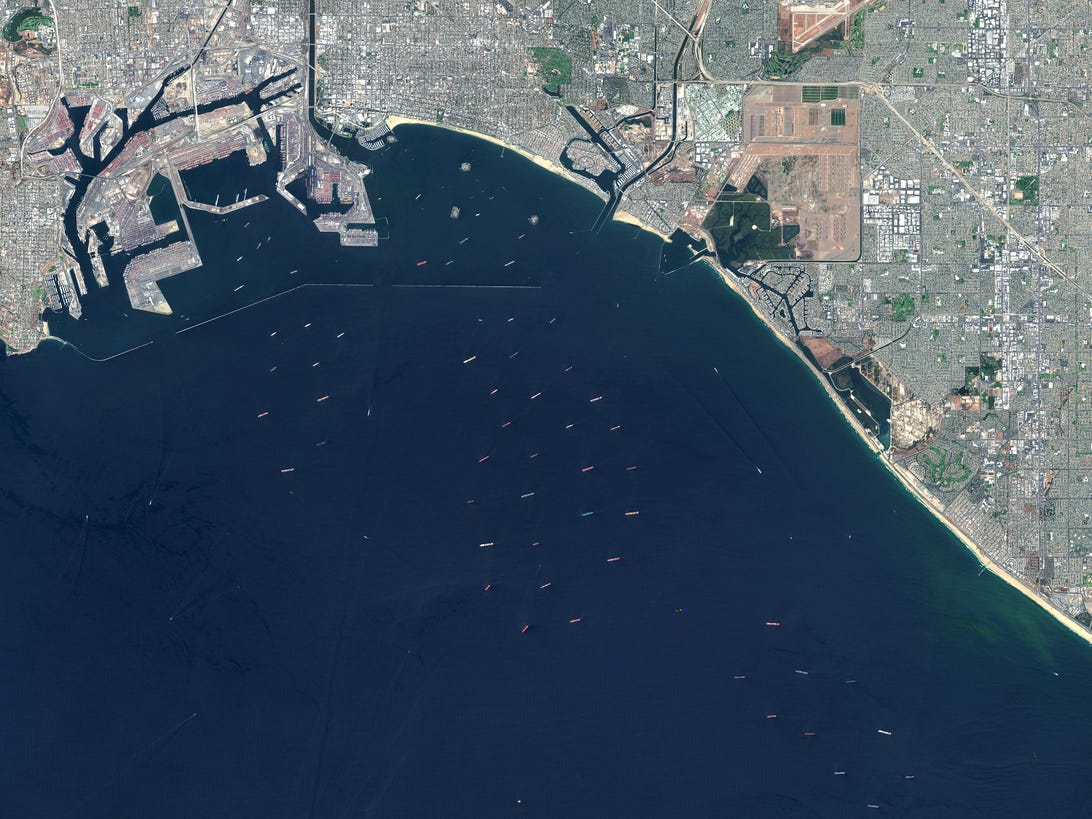 Satellite image of the ports of Los Angeles and Long Beach, with dozens of ships offshore