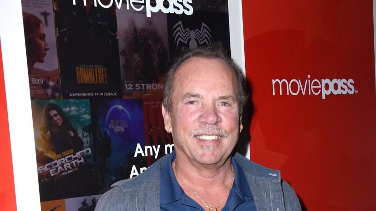 J. Mitchell Lowe in front of a MoviePass poster