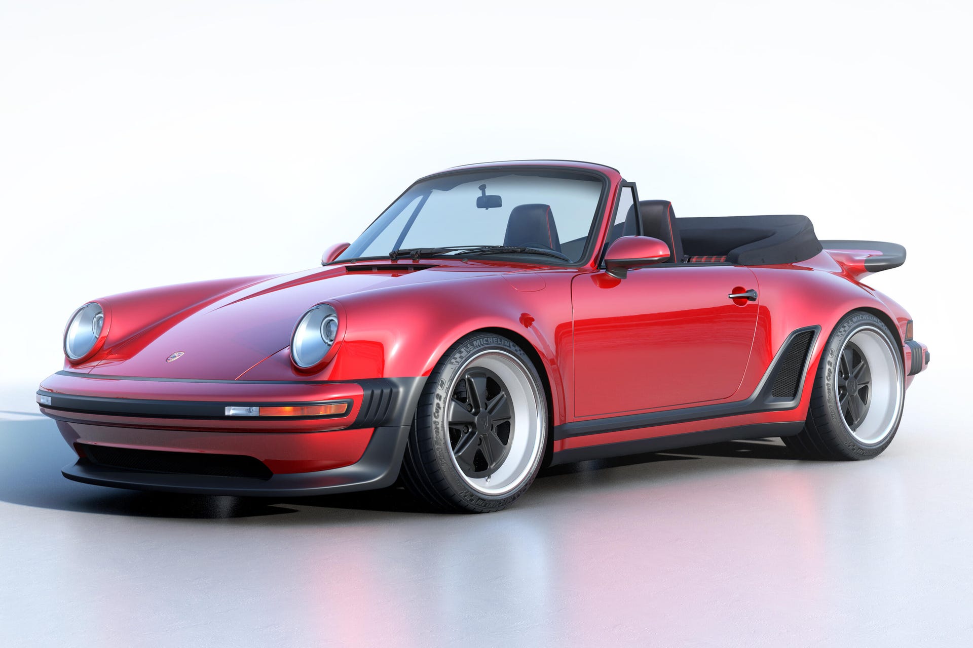Front 3/4 view of a red Singer Reimagined Porsche 911 Turbo Study Cabriolet