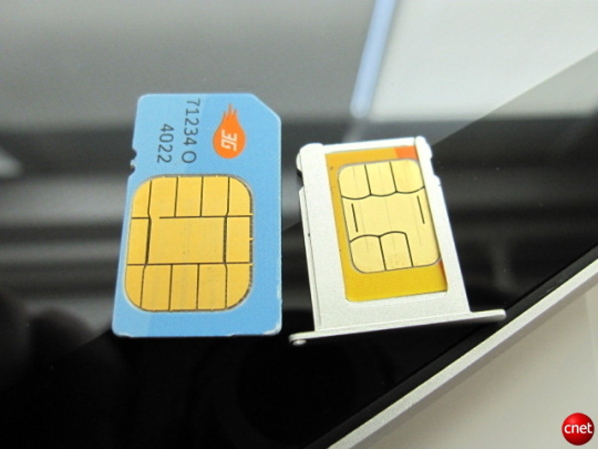 A standard SIM card next to a MicroSIM card, which ships inside 3G versions of the iPad.