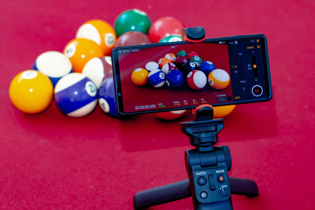 Phone on tripod filming a triangle of billiard balls