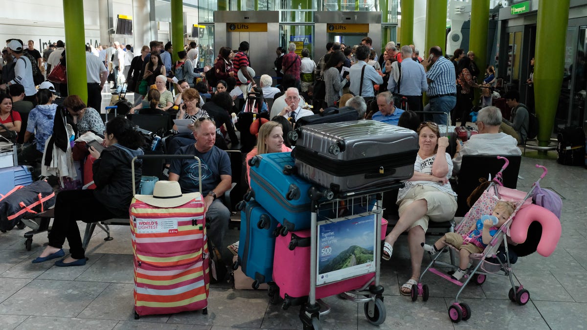 Travelers stranded at Heathrow Airport's Terminal 5 after British Airways canceled flights due to an IT systems failure.