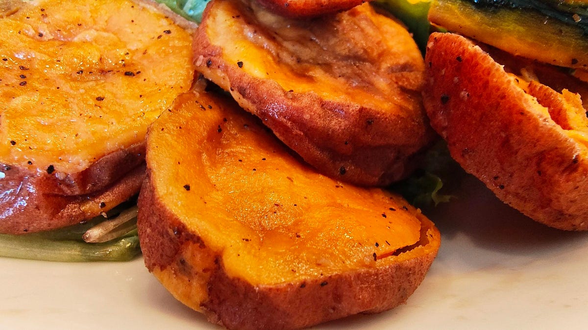 A close-up of a seasoned sweet potato, crispy on the outside and moist on the inside (which one can tell from the sharp photo).