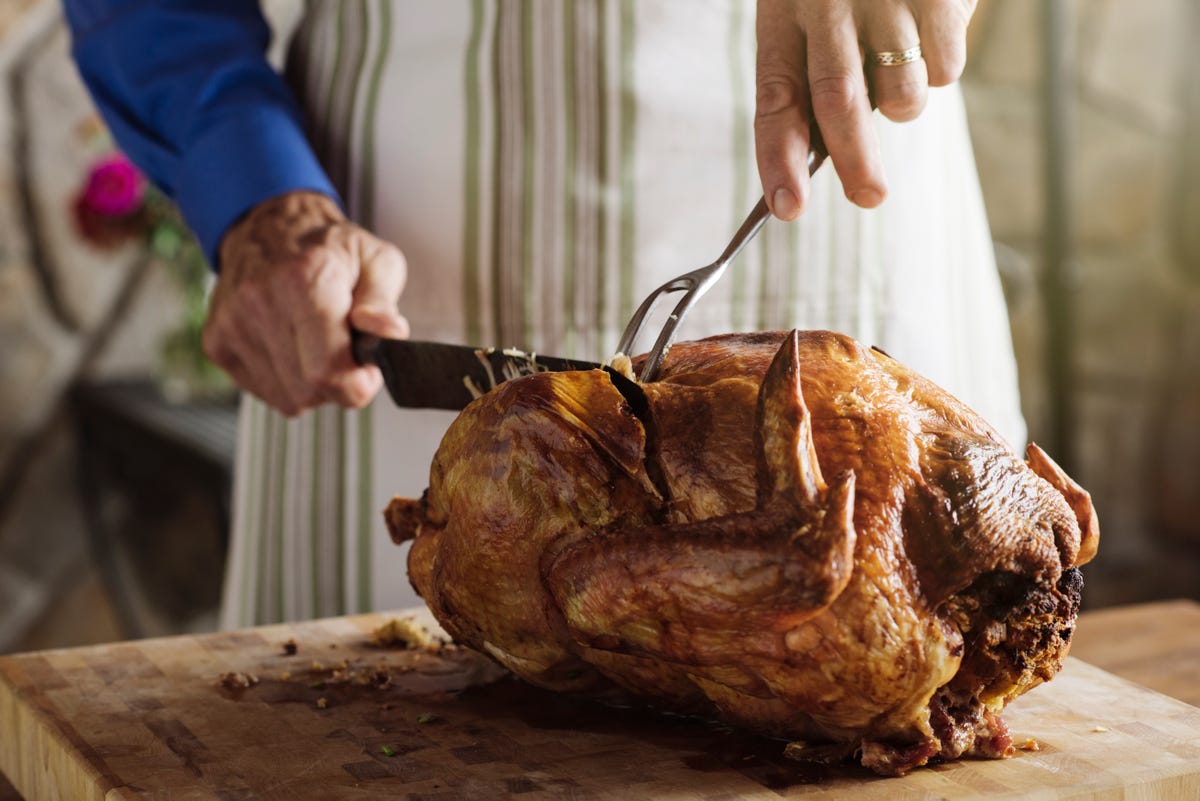man carving turkey