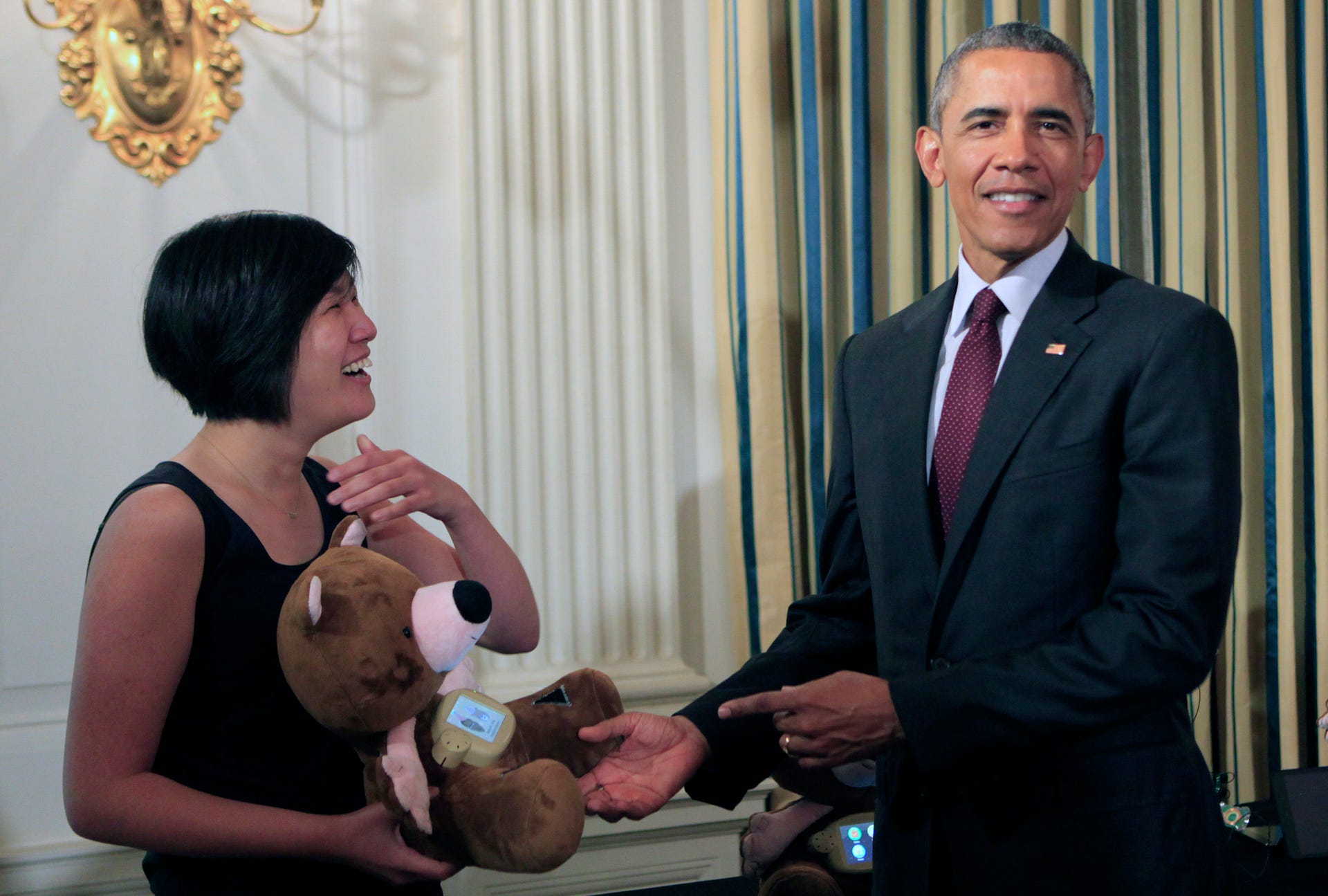 Obama checks out a high-tech teddy bear at the first-ever White House Demo Day, this past August. The president is currently pushing an initiative that will help train low-wage workers for well-paying technology jobs.