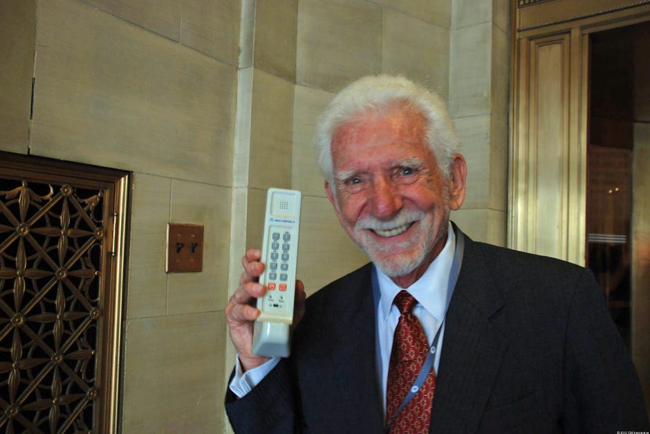 Motorola's Martin Cooper holds a Dynatac 8000x cellphone